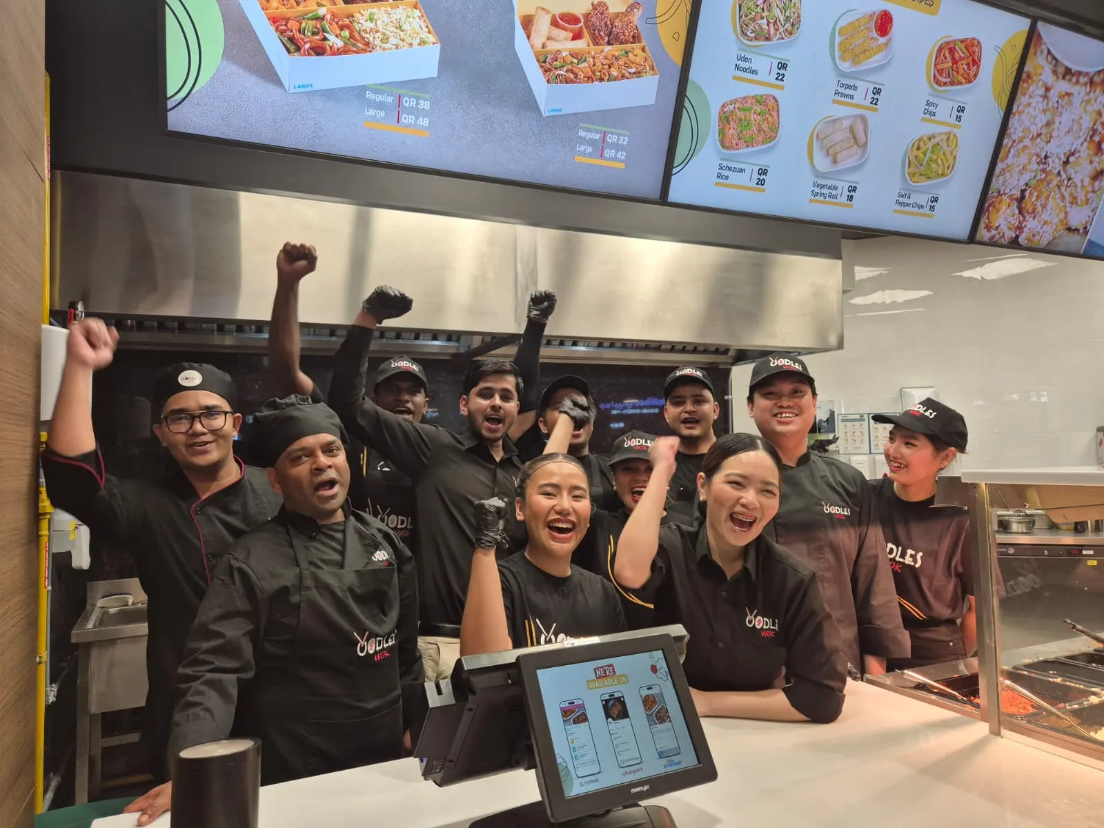 The Doha Festival City crew celebrating behind the counter